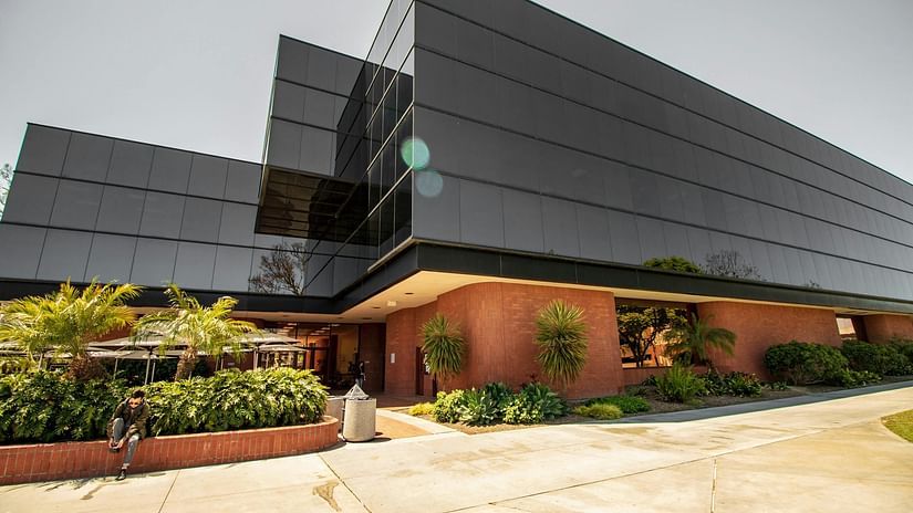 The exterior of a contemporary building, possibly the guest house or hotel, with sleek architecture.