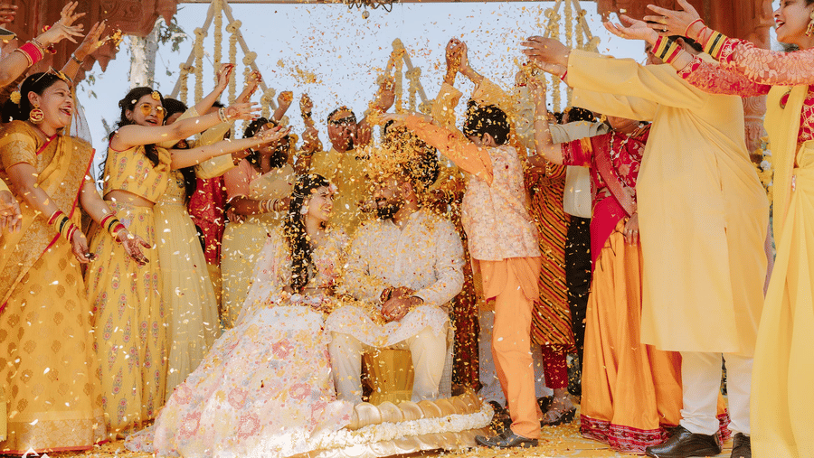 Family and friends celebrating a joyful haldi ceremony with the couple at Umaid Palace.