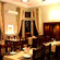 Hotel Devnadi, Haridwar | A dining space with chairs, tables, and a fan.