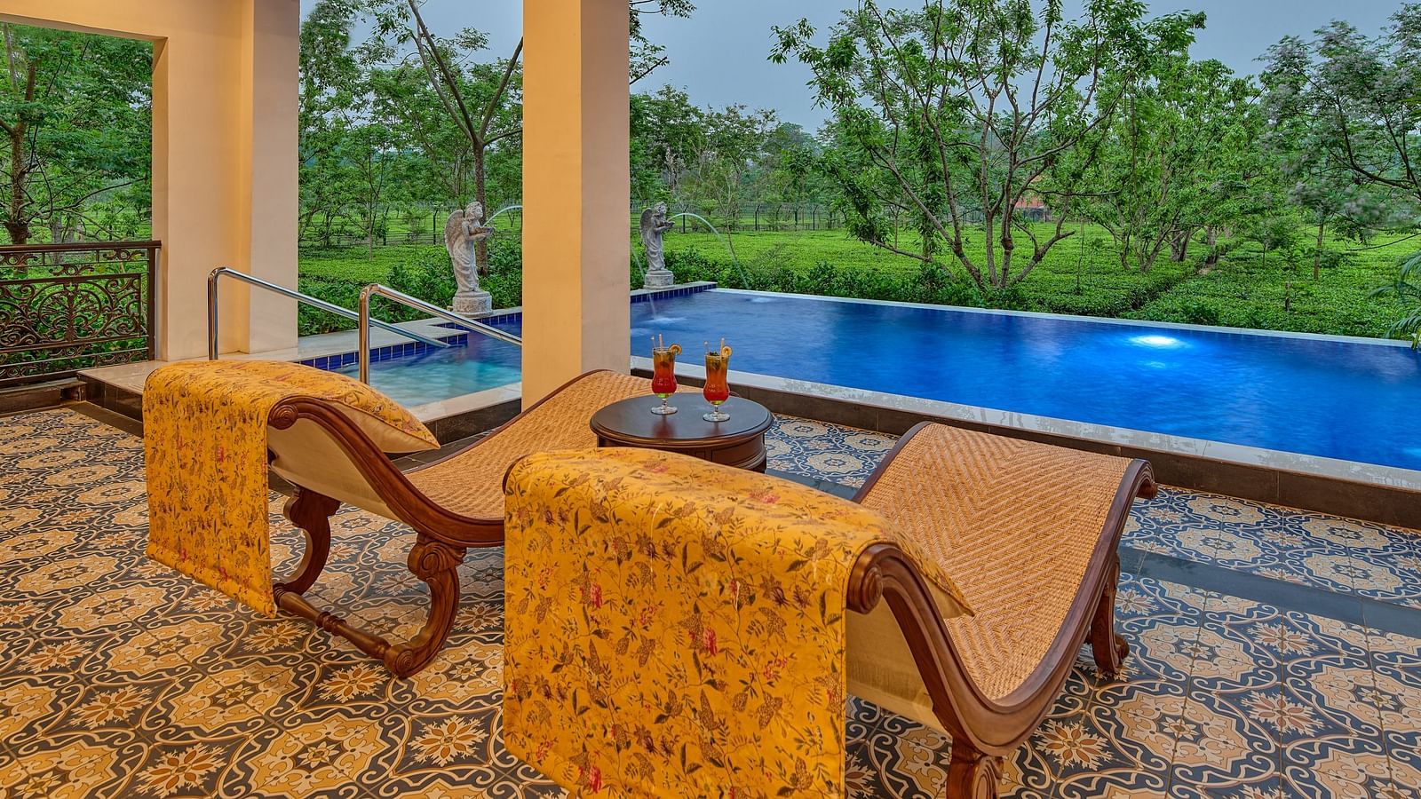 Outdoor seating with private pool and lush greenery view at MAYFAIR Tea Resort, Siliguri