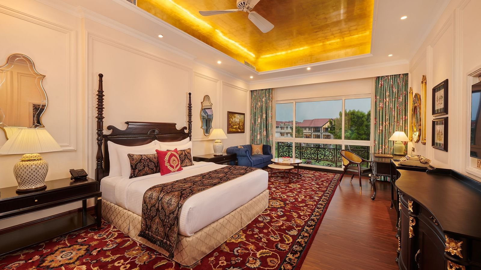 Spacious bedroom with golden ceiling and access to outdoor balcony at MAYFAIR Tea Resort, Siliguri