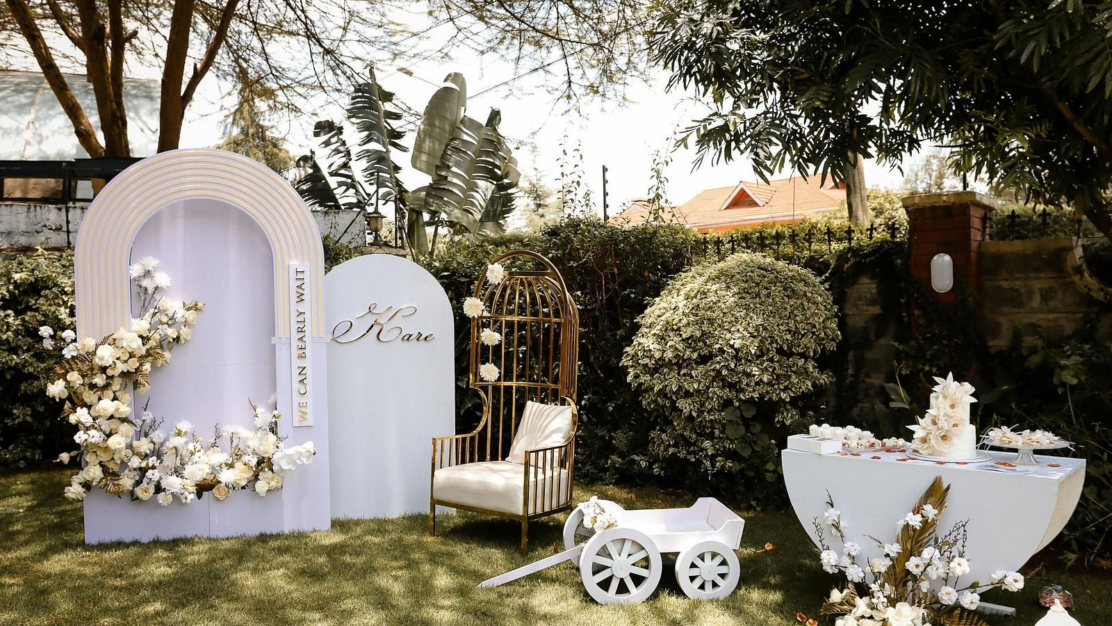 Outdoor garden setup decorated for a special event with floral arrangements.