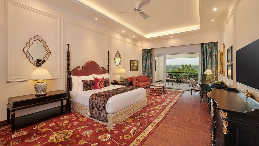 Elegant twin-bed room with vintage decor and red patterned carpet.