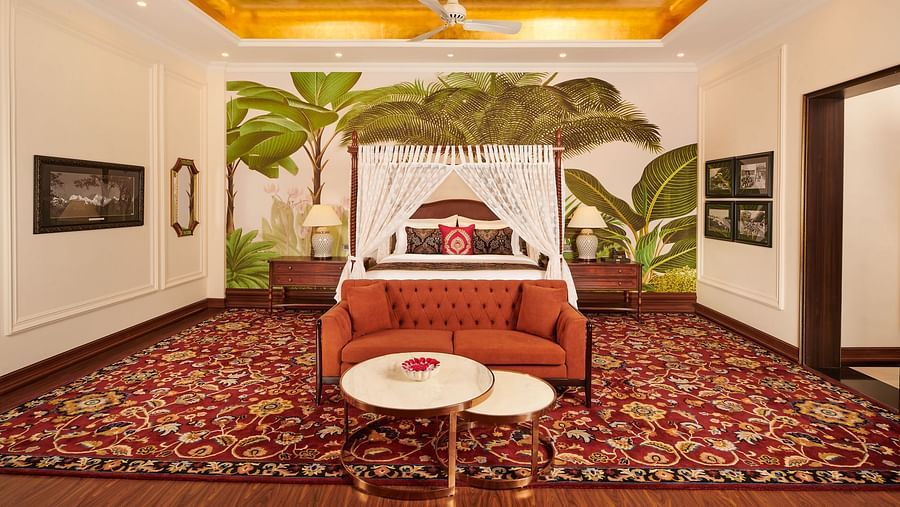 Spacious room with vintage-style canopy bed and tropical wall art.
