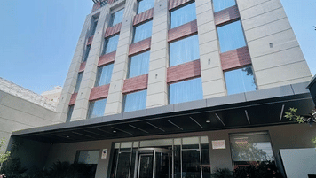 Exterior view of the Ramada Encore by Wyndham Chandigarh Zirakpur building captured from a lower angle, showing multiple floors and architectural structure.