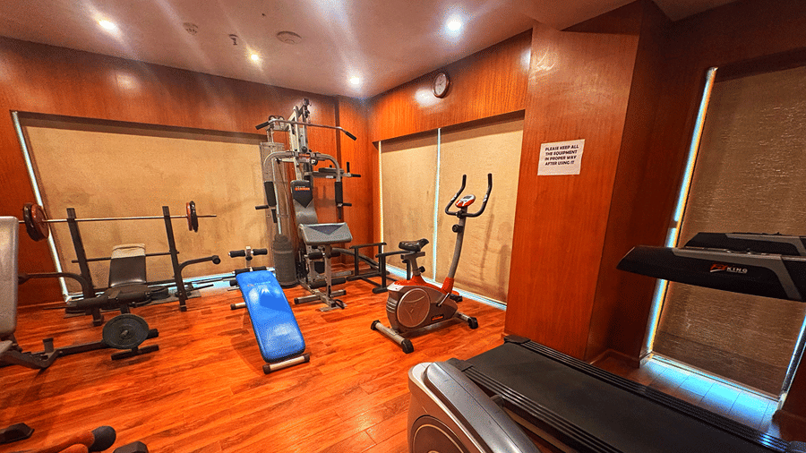 A wide angle shot of the gym with beige roll down curtains covering the windows at the Senses Hotel.