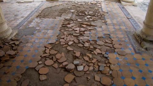 broken floor tiles in the centre and intact tiles on the sides - The Baradari Palace