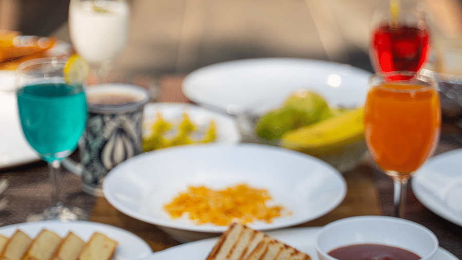 A close up shot of a drink placed along with various meals on the table at the Sylvan Retreat, Dehradun.