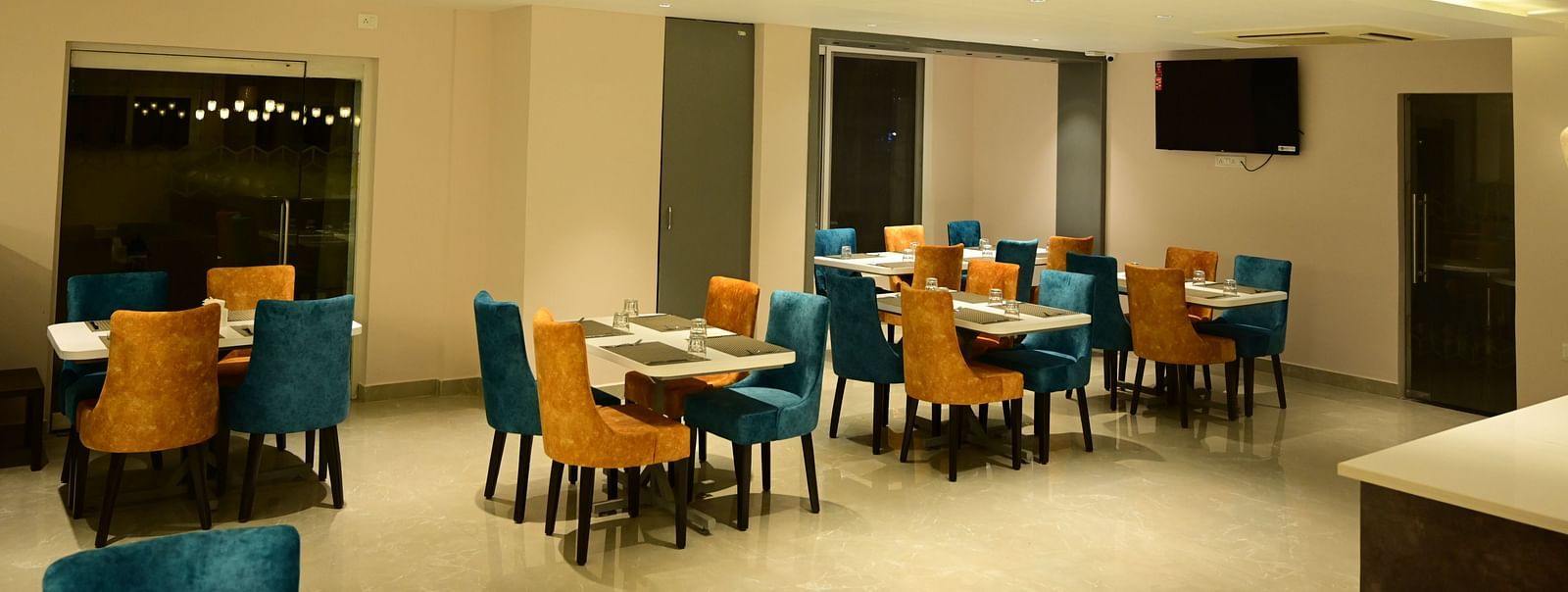 Blue and Yellow coloured chairs at the restaurant at Sterling Keys by TGI in Bnagalore
