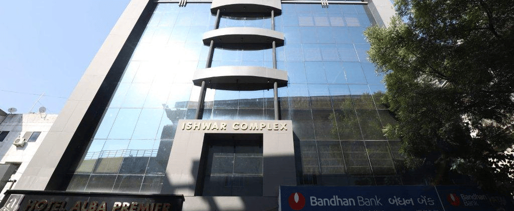 A bright facade of Pravasa Stay, Ahmedabad (Alba Premier), taken on a sunny day with a clear blu sky in the background.