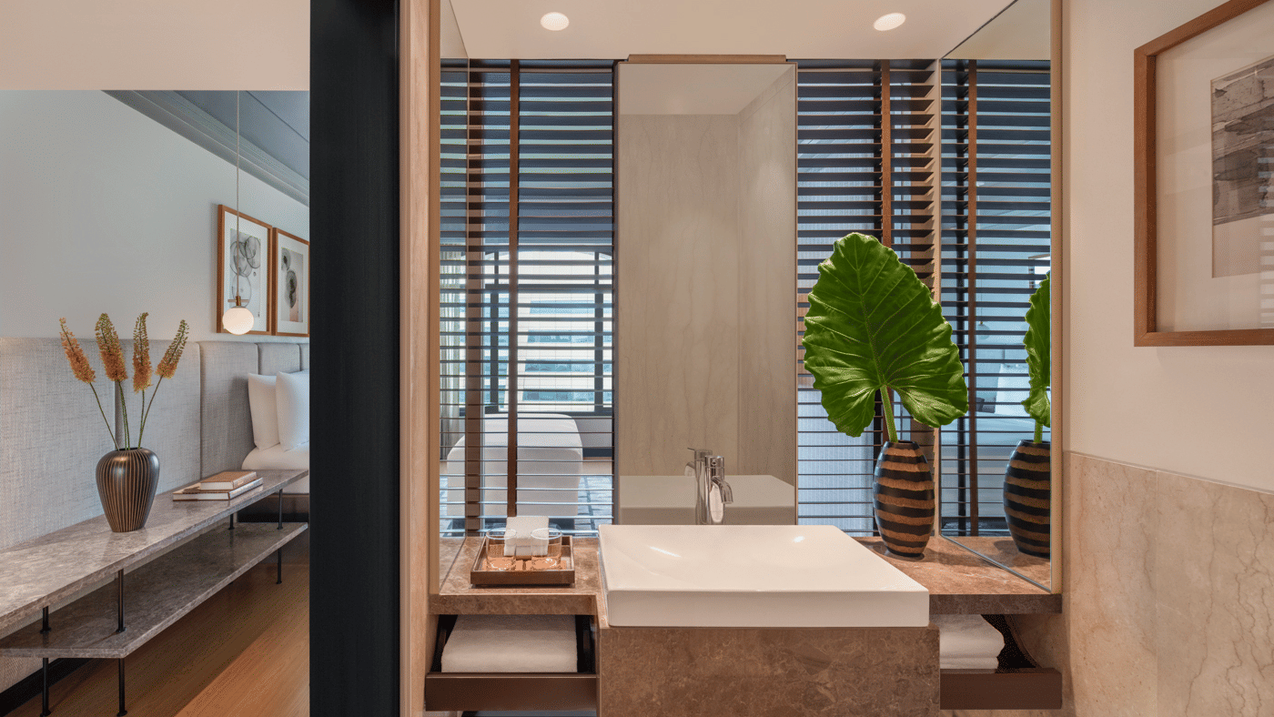 Bathroom with shower area, sink, and wall mirror at The Raintree, St. Mary’s Road.