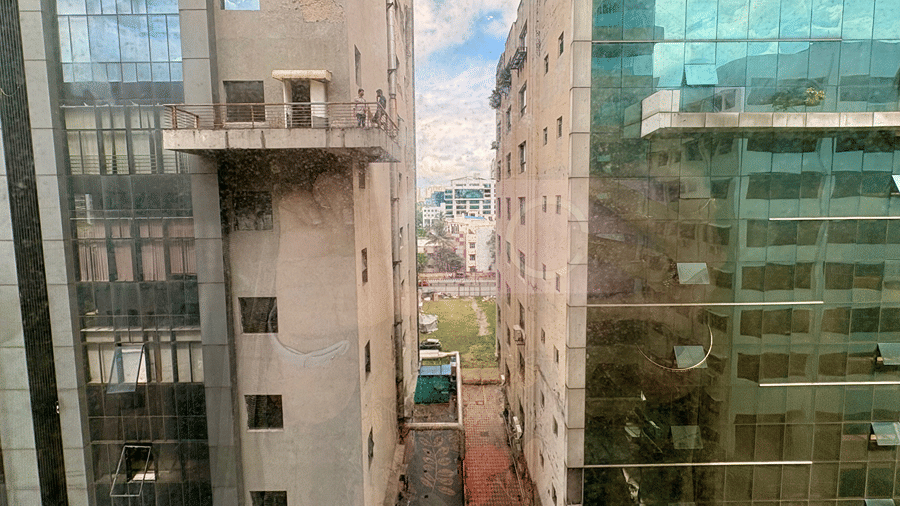 A view of the cityscape and a partly cloudy sky seen from the glass windows in the Senses Hotel.