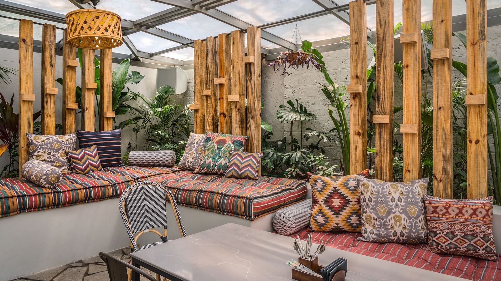 Cosy seating arrangements with cotton mattresses and glass ceiling at Village 36