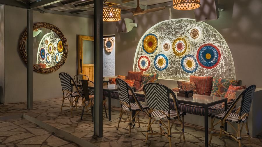 A minimalistic interior design with wooden light coverings and seating arrangements at Village 36
