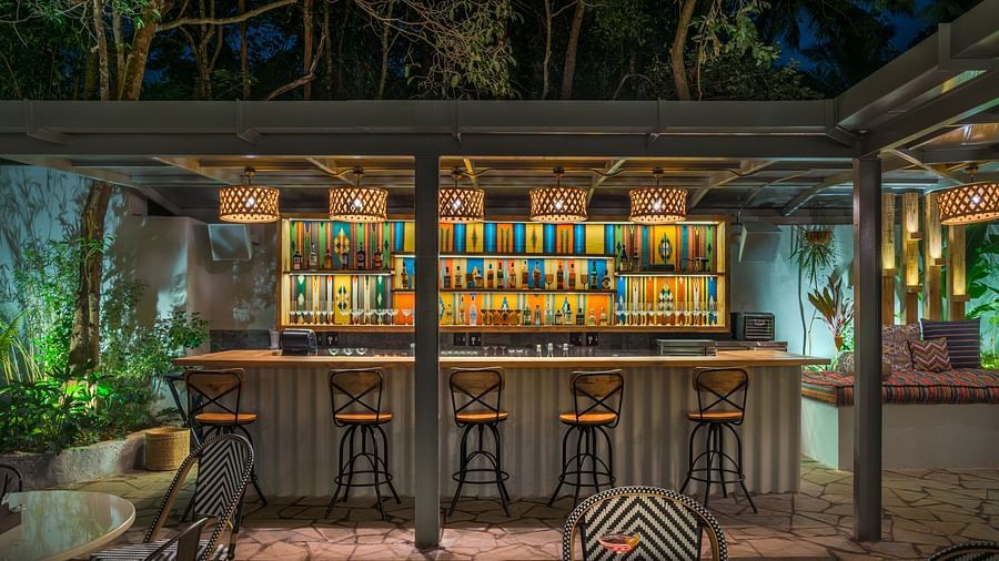 Bar section with different drinks showcased on the shelves behind at Village 36