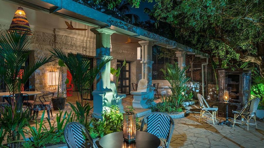 Outdoor seating arrangement with a lantern on the coffee table at Village 36