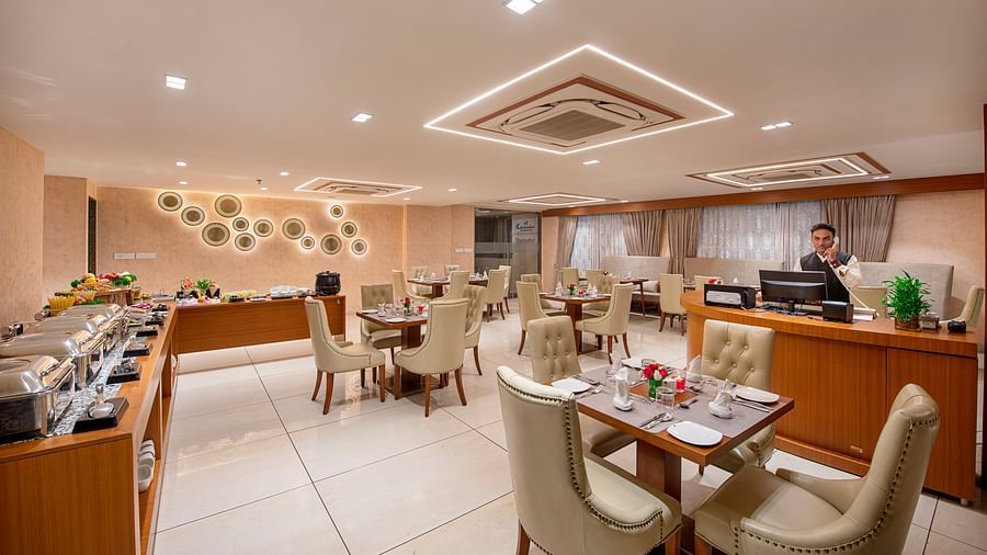 A view of a dining or event space within the hotel, showing table arrangements - SK Lords Inn Ahmedabad