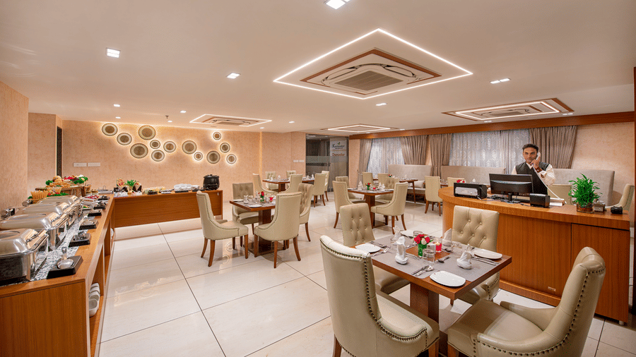 A view of a dining or event space within the hotel, showing table arrangements - SK Lords Inn Ahmedabad