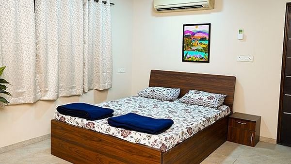 Spacious private room in a hostel with a large bed and minimalist decor | Diamond Parks, Pune 