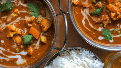 A spread of Indian cuisine with bowls of rice and curry. 