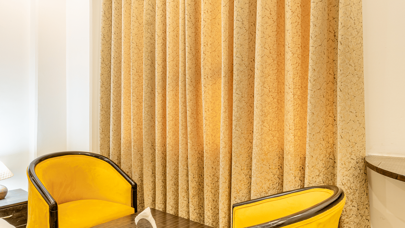 Two chairs facing each other in the superior double or twin room at Lime Tree Hotels and Banquet Hall Near Huda Metro, Gurgaon