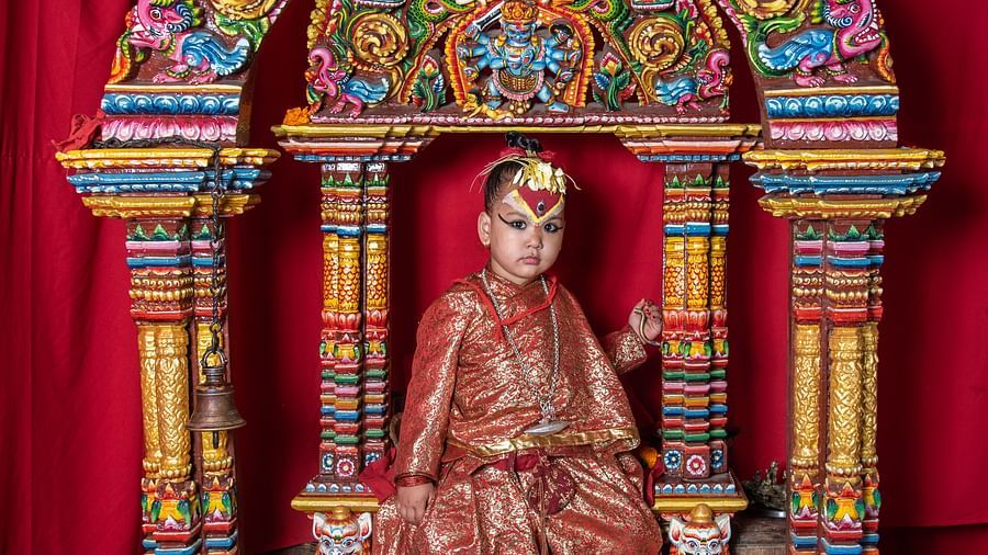 A young boy dressed as a deity