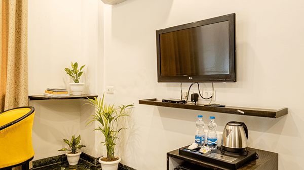 Modern hotel room with a television, work desk, and contemporary furnishings.