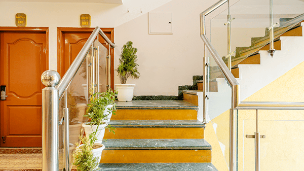 Modern hotel staircase and elevator lobby with elegant finishes.