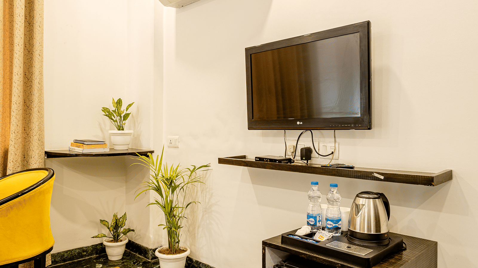 Modern hotel room with a television, work desk, and contemporary furnishings.
