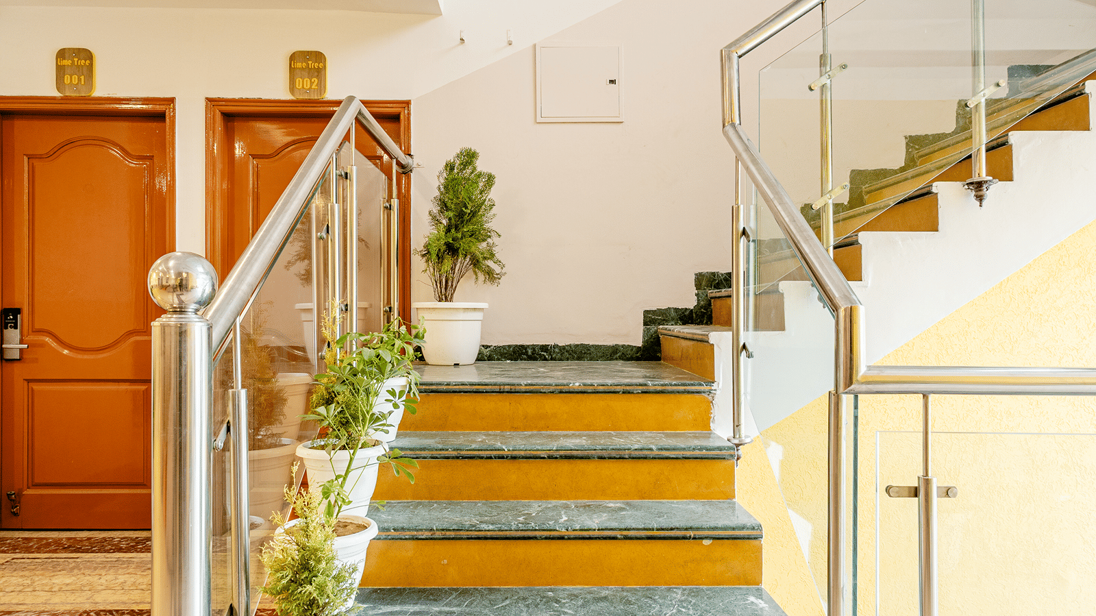 Modern hotel staircase and elevator lobby with elegant finishes.