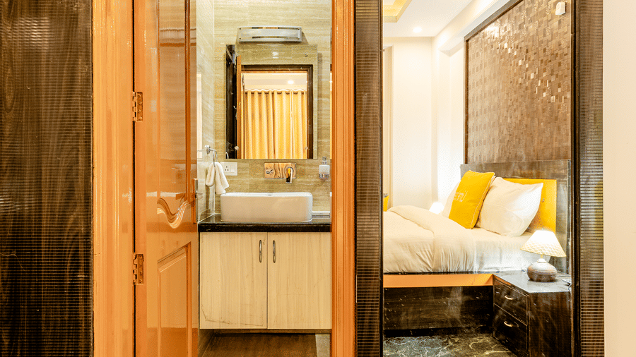 Entrance to a modern hotel bathroom connected to the  room.