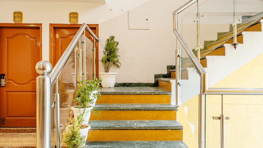 Modern hotel staircase and elevator lobby with elegant finishes.
