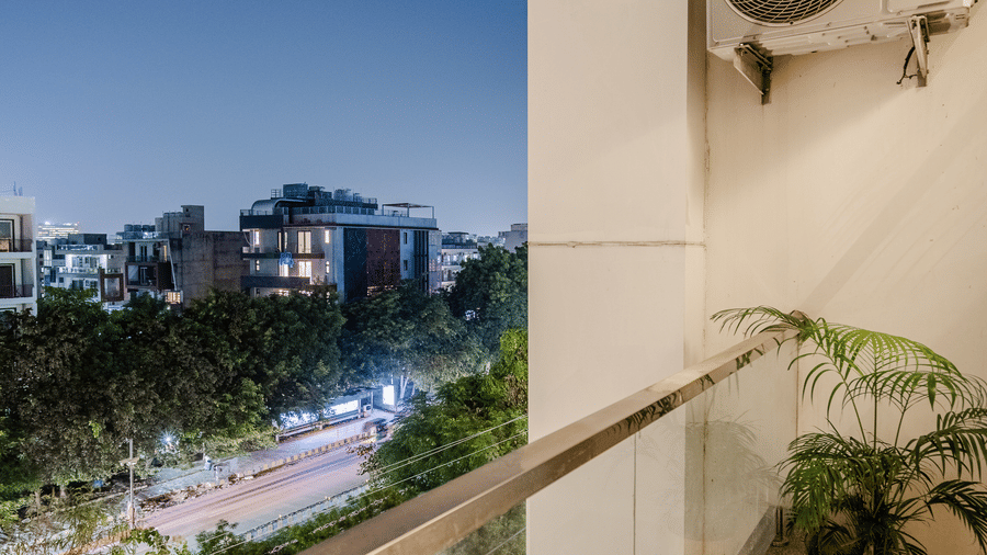 Balcony of Lime Tree Luxury Studio featuring a potted plant and an evening view of the surrounding cityscape.