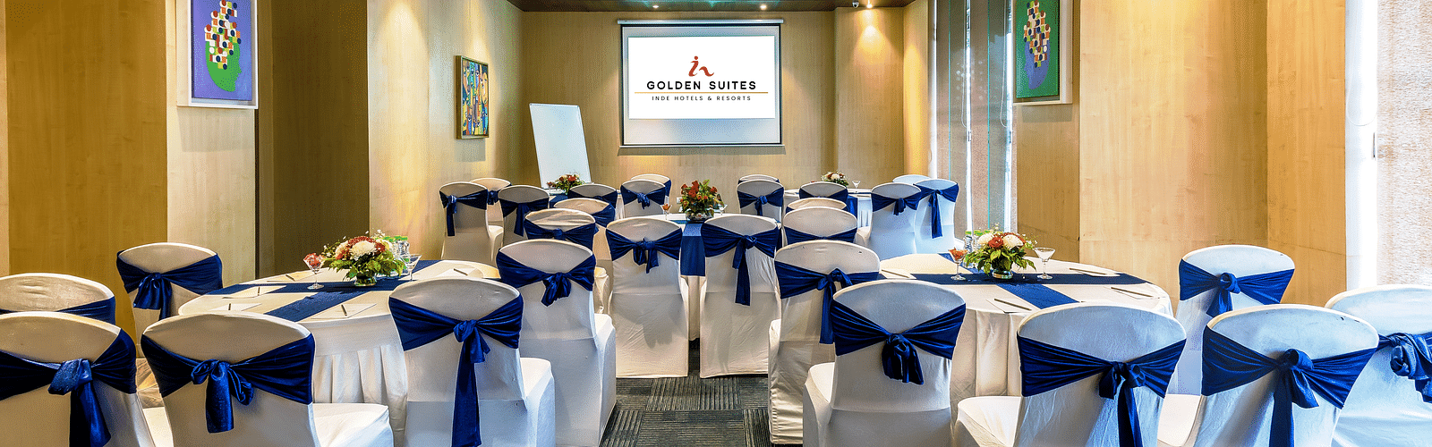 Senate 1 banquet hall with a decorated chair and screen presenter