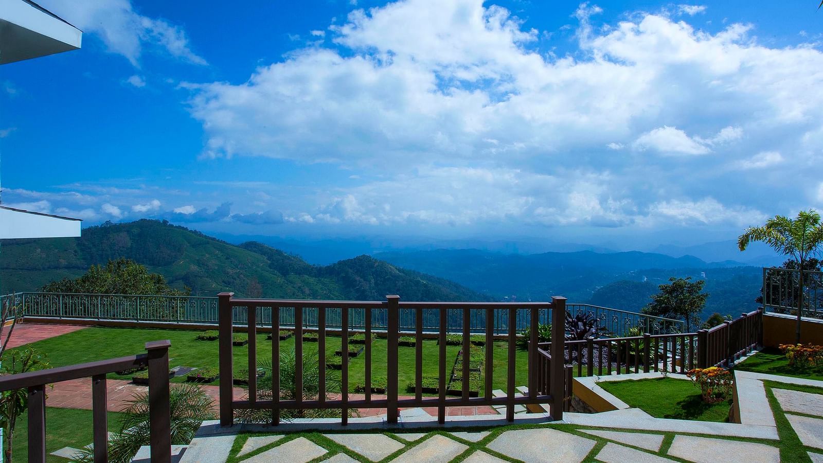 Half cloudy sky and mountain view from the balcony at Fragrant Nature Munnar