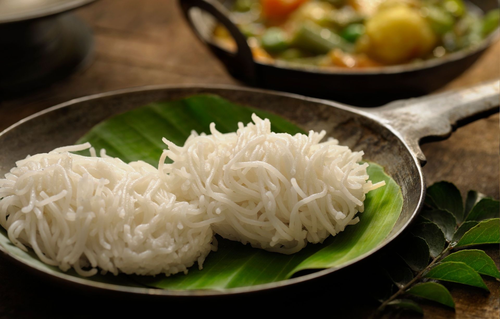 String hoppers (Idiyappam) on a banana leaf.