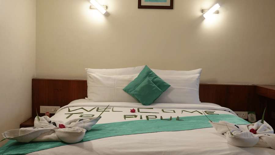 Cosy double bedroom with soft lighting and minimalist decor at Pipul Utkal Continental, Jharsuguda.