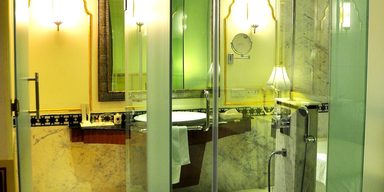 Image of a washroom with glass cubicle at Rajasthali Resort & Spa Jaipur.