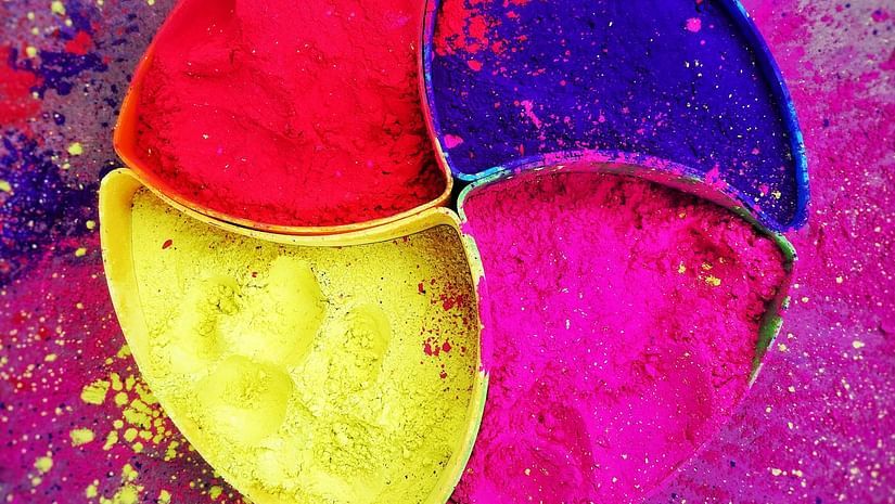 Vivid bowls of colored powder arranged in a circle, celebrating the joyful festival of Holi.