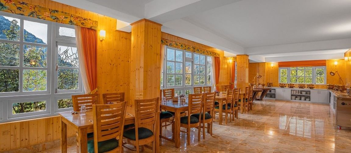 Image of a restaurant with sitting area and view of the mountain in front at Summit Gangchen Hotel, Lachen