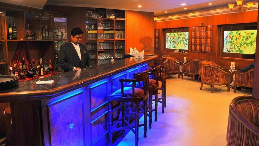 The interior of Nalapad Hotel Bangalore International featuring a lounge area with seating and televisions. 