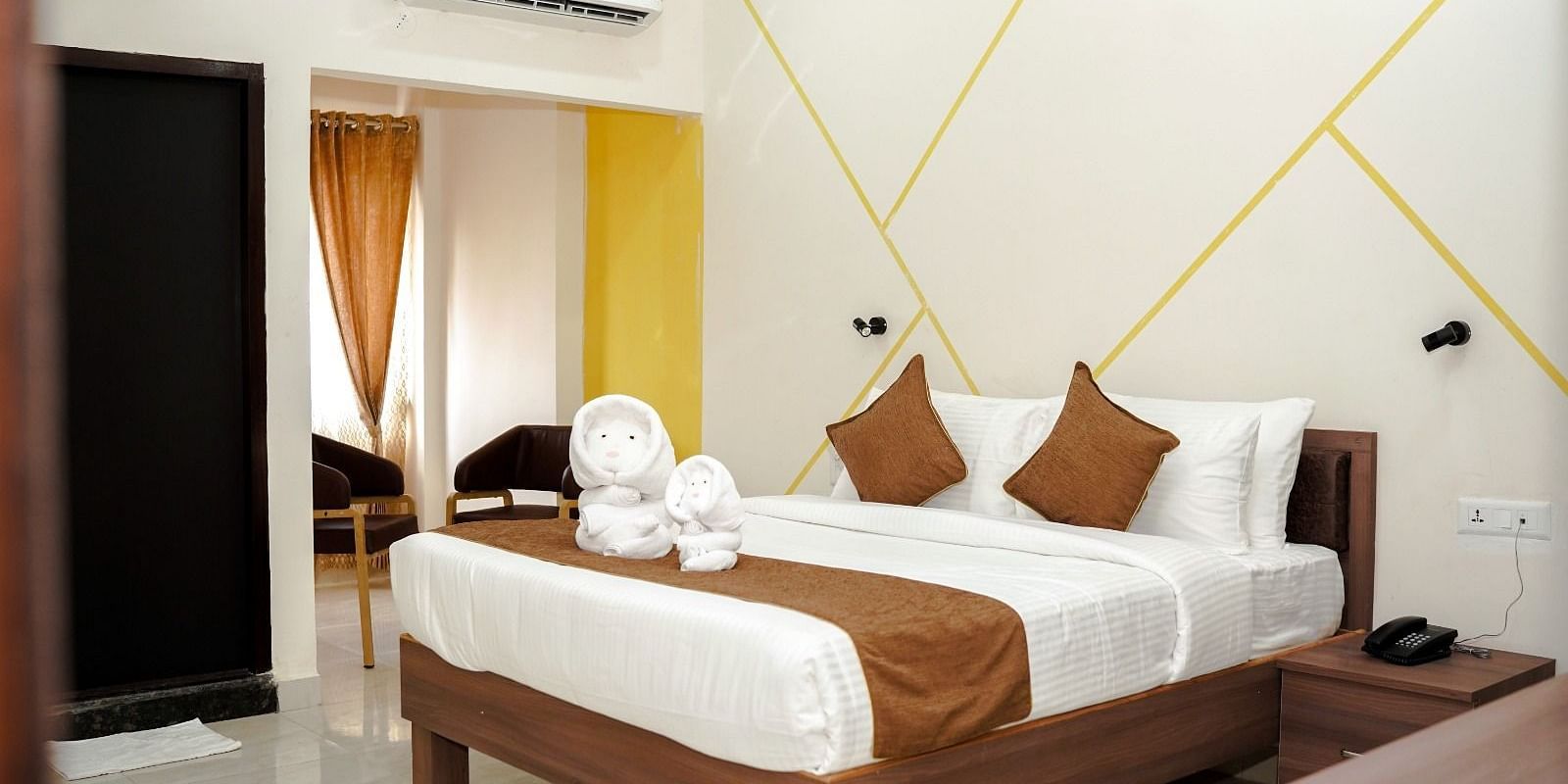 A well-lit room with a double bed at ANS M Square Hotel & Resort, Kalaburagi