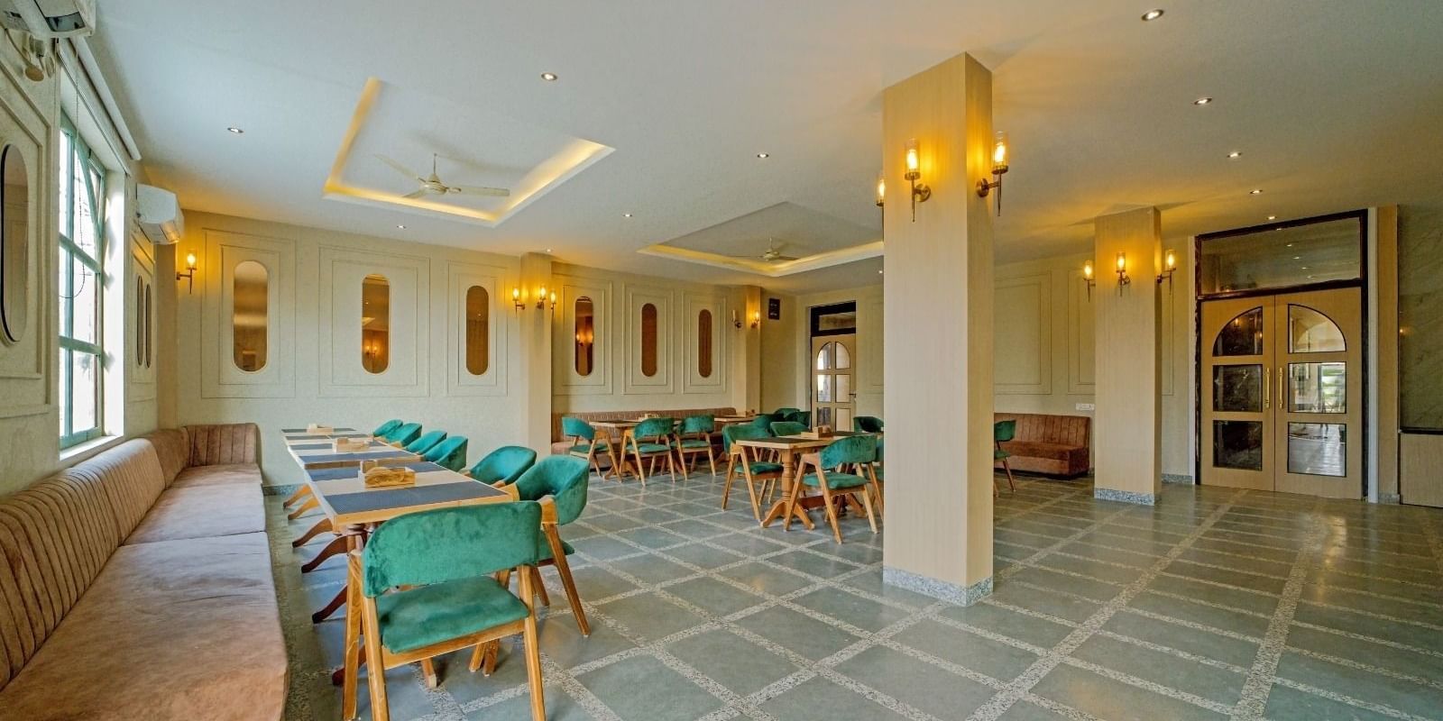 Dining area at Grassfield Riviera Resort, Jaipur, featuring stylish seating, soft lighting, and a spacious, elegant atmosphere.