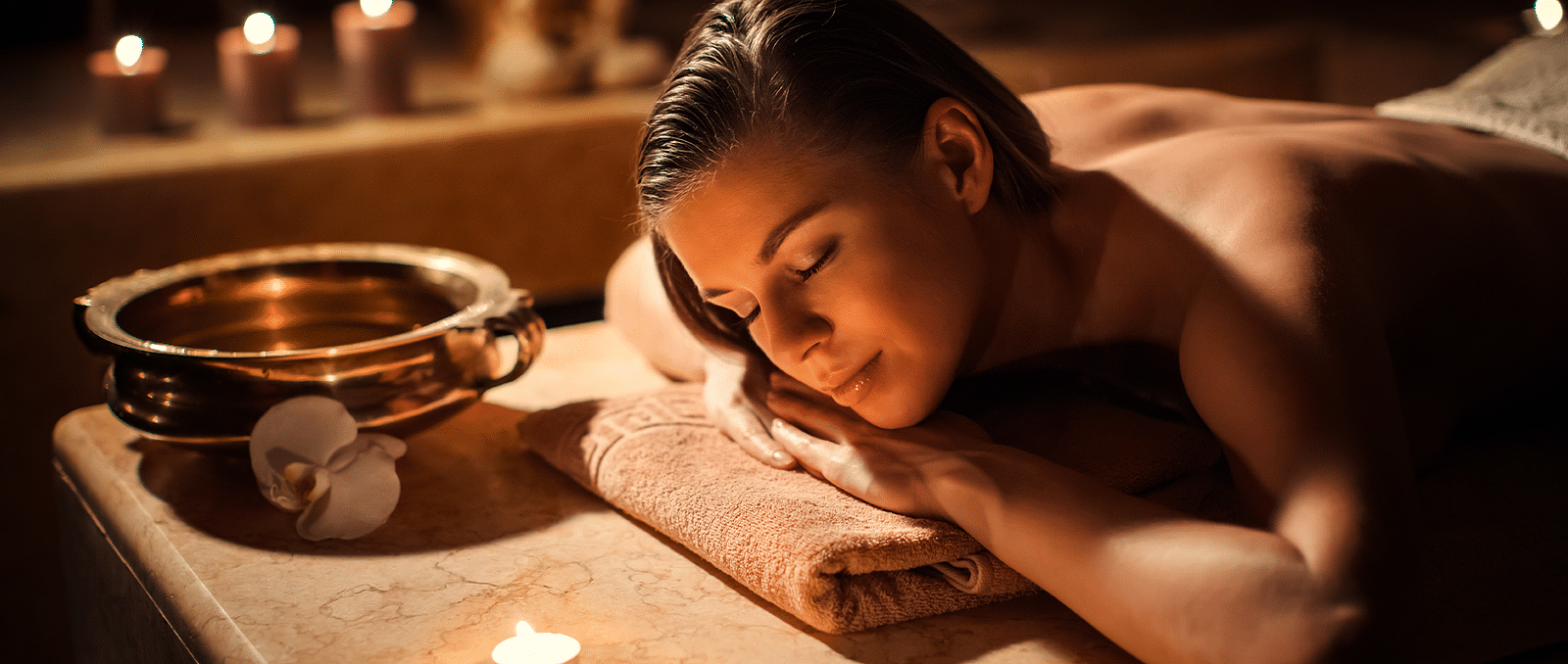 A woman receiving soothing and relaxing massage in spa