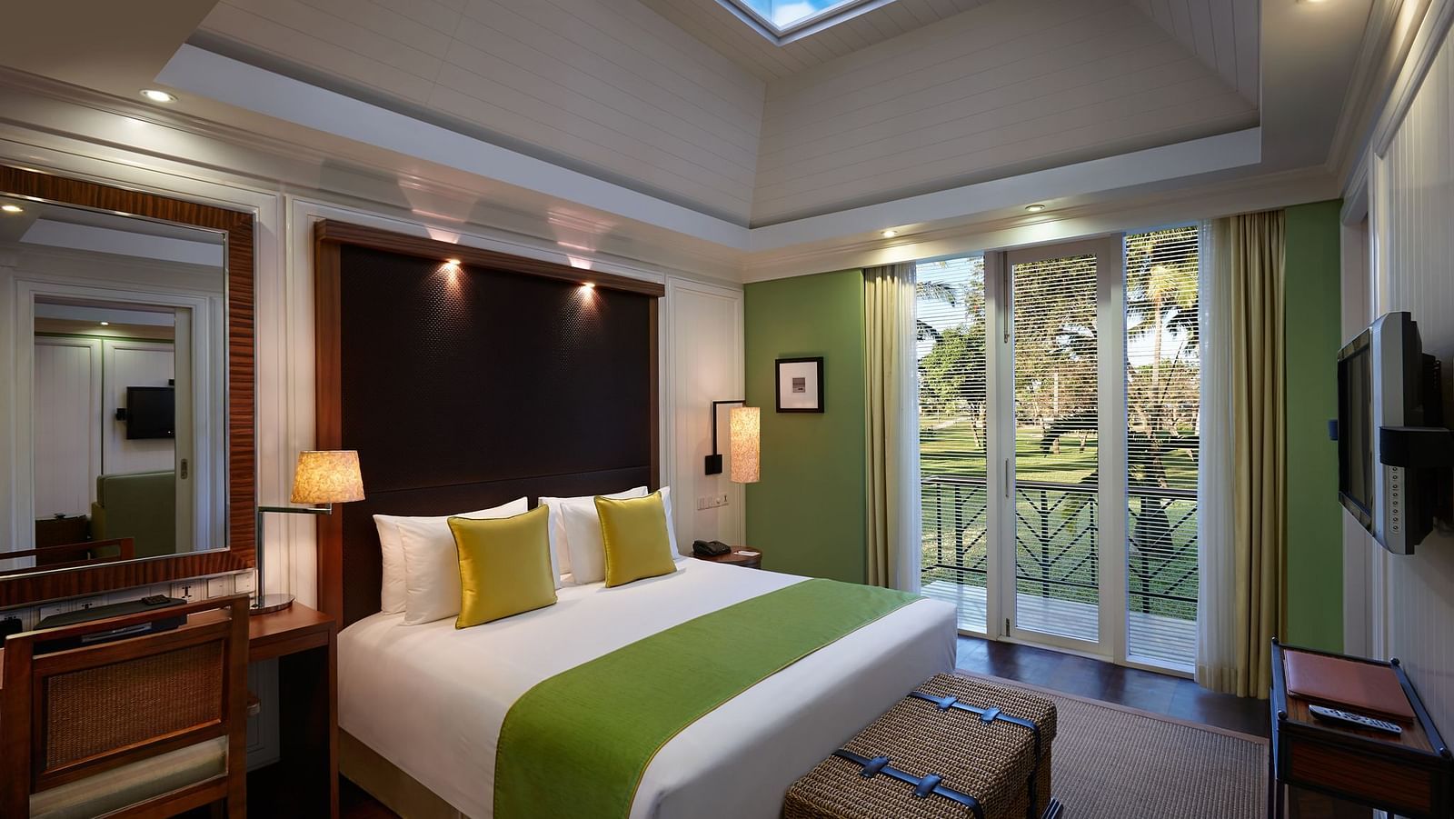 a double bed with side tables and lamps inside Presidential Villa Master Bedroom - Caravela Beach Resort Goa