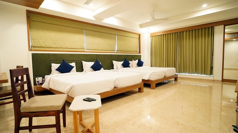 Family room featuring two sets of double bed, a mini table and chair.