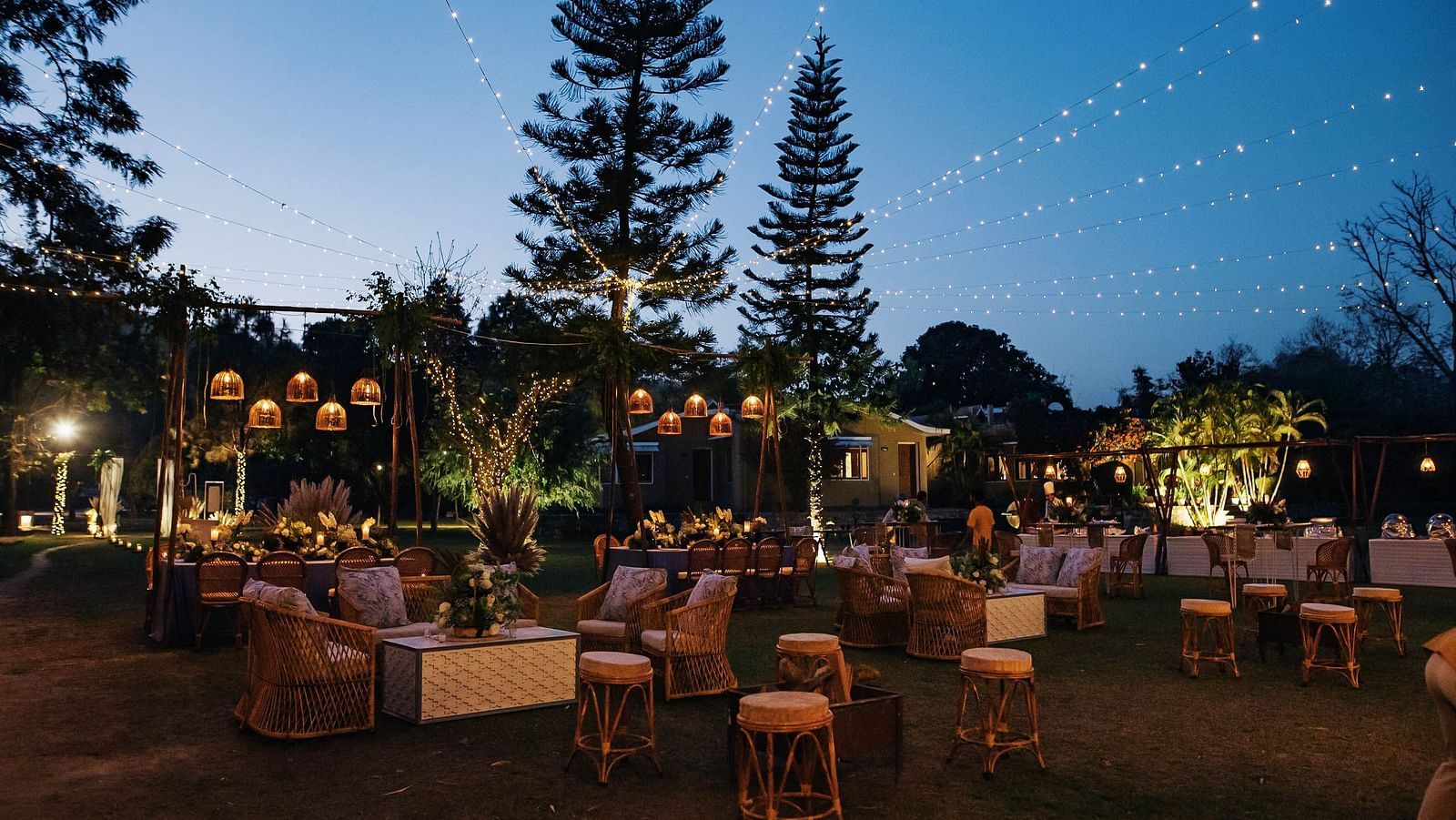  An image of a outdoor banquet hall with chairs and a stage decorated for destination wedding halls - The Riverview Retreat, Corbett