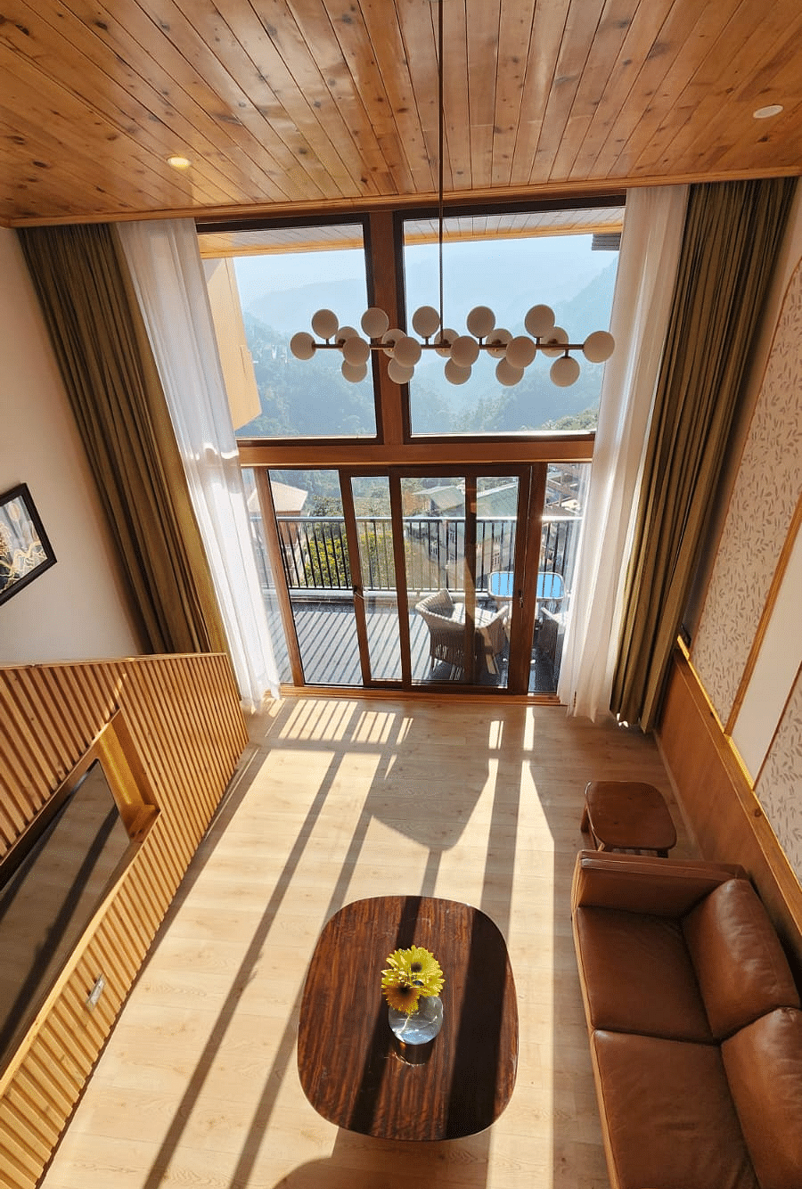 Image of a penthouse with seating area and wooden interiors at Summit Hotels & Resorts.