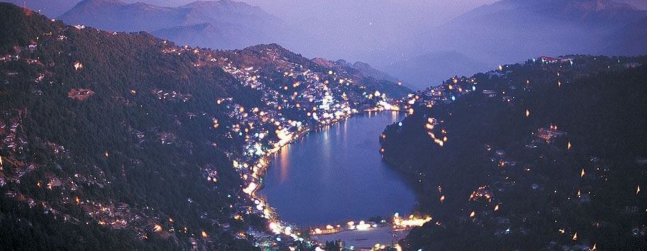 Panoramic view of lake with buildings and mountains on the sides