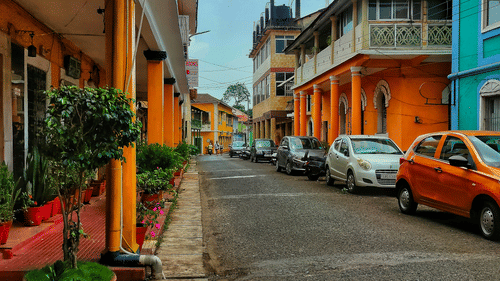 An overview of Fontainhas area with old buildings, a road and many cars parked on the side, making it one of the must-visit Cultural Places in Goa